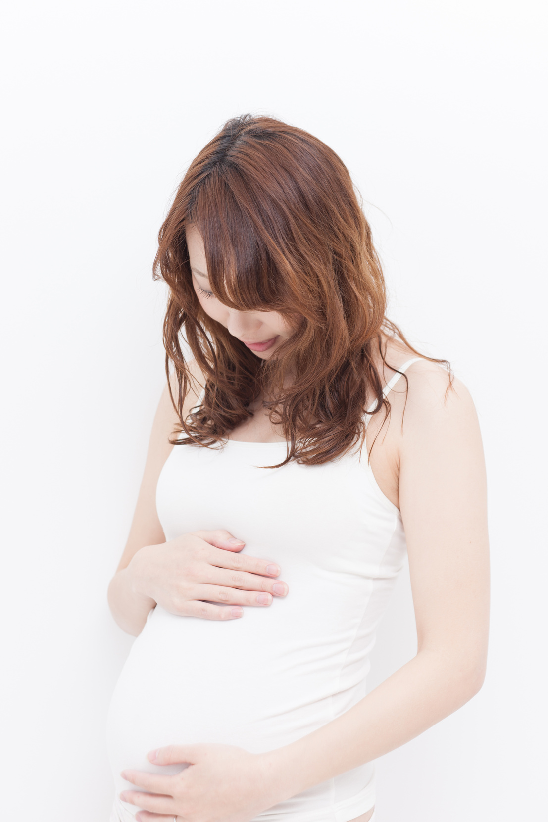 Pregnant Japanese woman holding belly